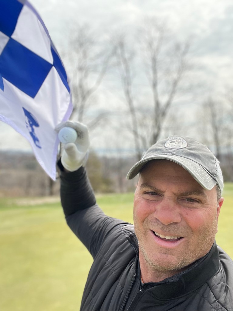 Steve Vassi at the hole after his hole-in-one at Patriot Hills Golf Club